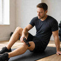 Using the massage gun on a calf muscle