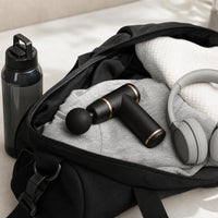 Massage gun packed in a gym bag