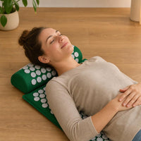 Person relaxing on the acupressure mat at home